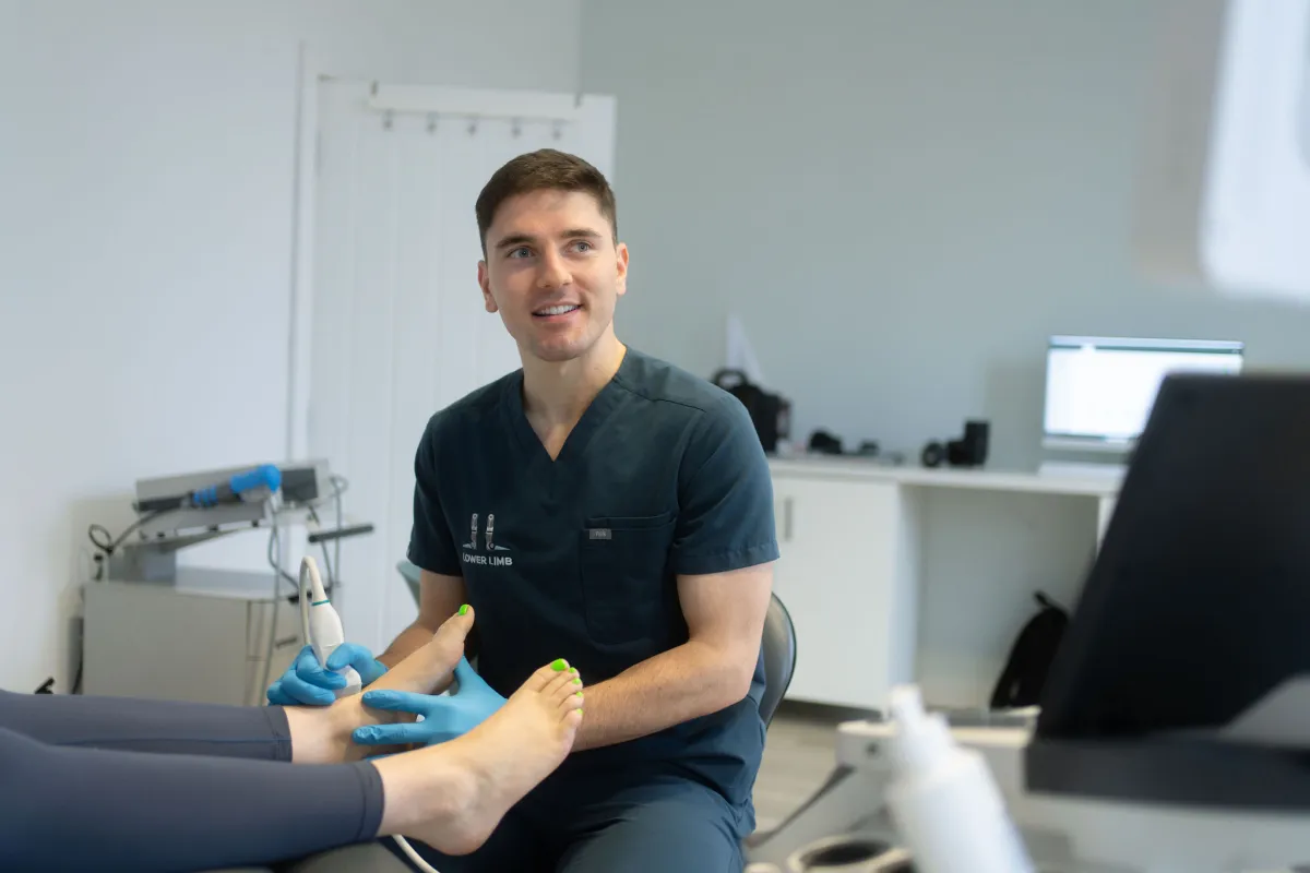 Podiatrist performing a diagnostic ultrasound scan for shockwave therapy planning at Lower Limb Clinic Belfast